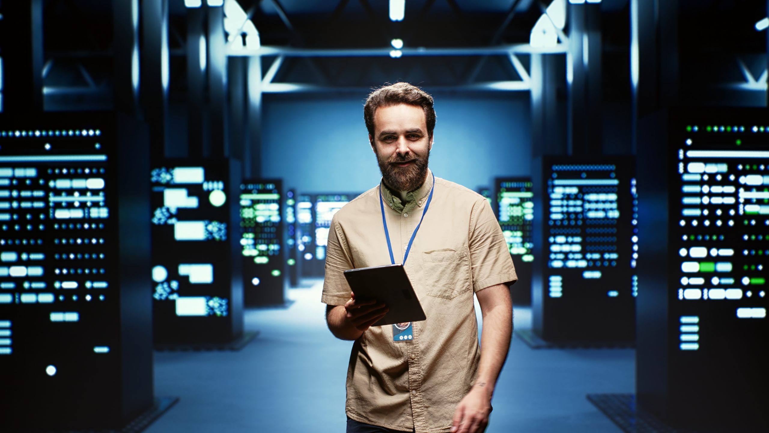 Engineer in high tech facility Engineer in high tech facility delivering immense computing power, capable of processing and storing vast amounts of data. Technician walking between server racks rows controlling network resources